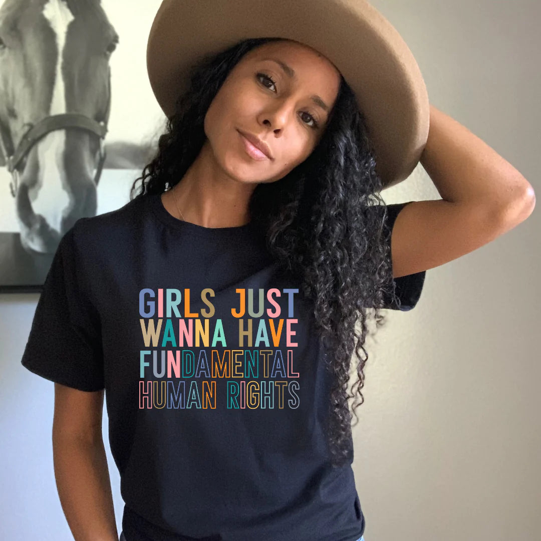 A black cotton t-shirt with a powerful statement that reads, "Girls Just Want To Have Fundamental Rights." This empowering t-shirt celebrates the fight for gender equality, featuring bold typography and a clear message. Perfect for making a statement and sparking conversations, it showcases the importance of equal rights for girls and women in a stylish and impactful way.