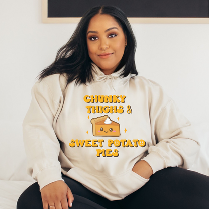 Sand-colored hoodie featuring a playful graphic that reads 'Chunky Thighs and Sweet Potato Pies.' Stay cozy and express your unique style with this fun and comfortable sweatshirt.