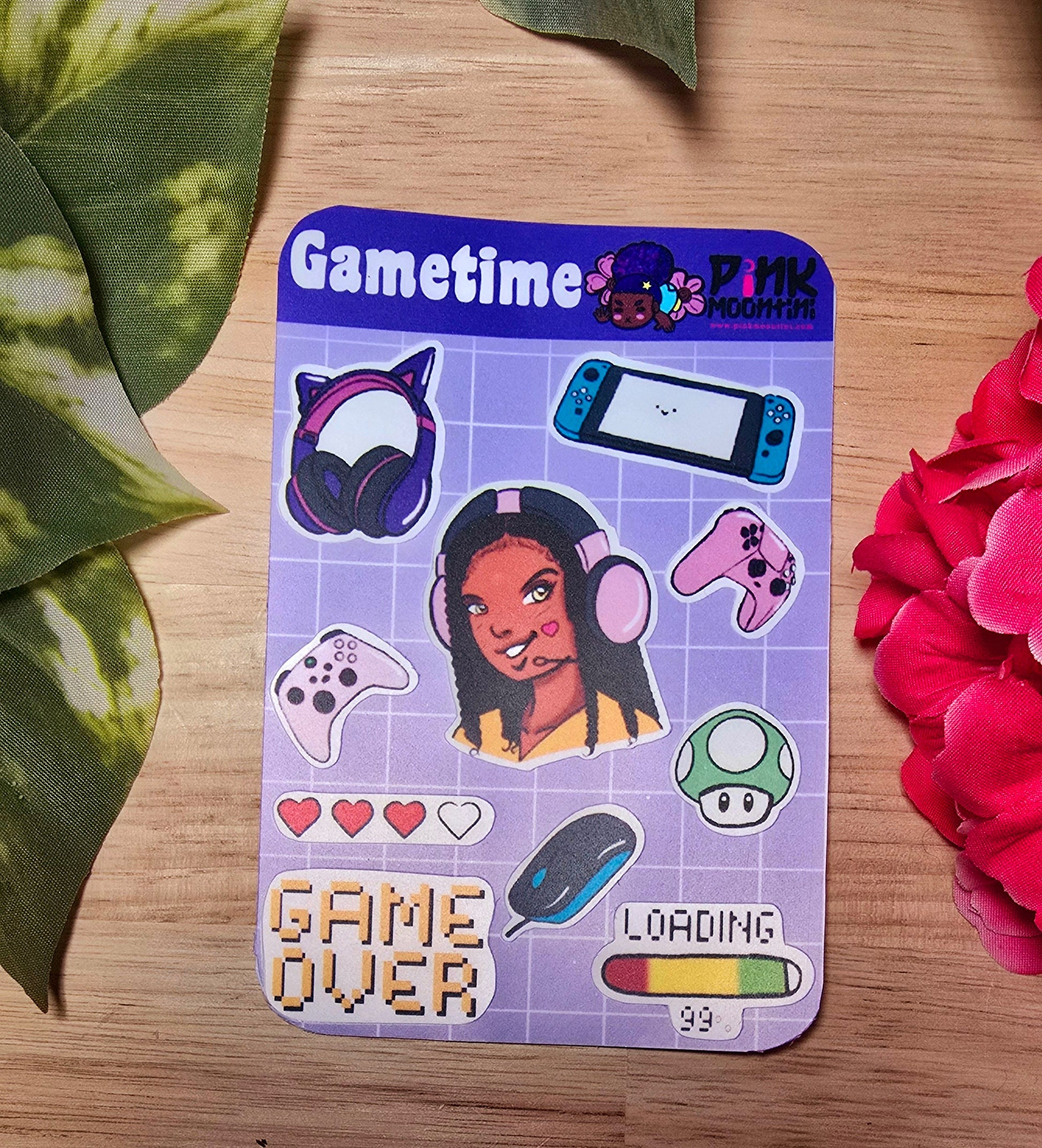 purple video game related sticker sheet on wooden surface