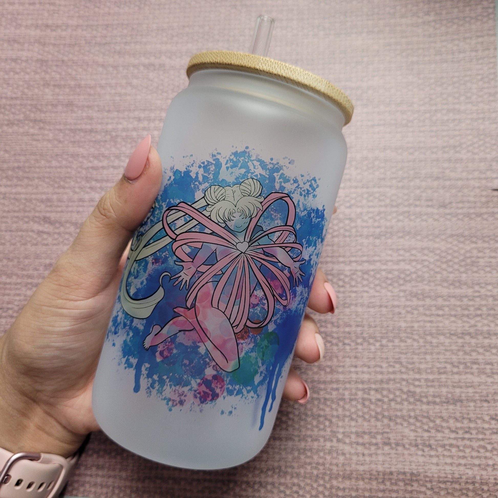 16 oz frosted Sailormoon cup with bamboo lid - a clear cup with a frosted finish featuring Sailormoon character artwork. The cup has a capacity of 16 oz and is topped with a bamboo lid to prevent spills and keep drinks hot or cold.